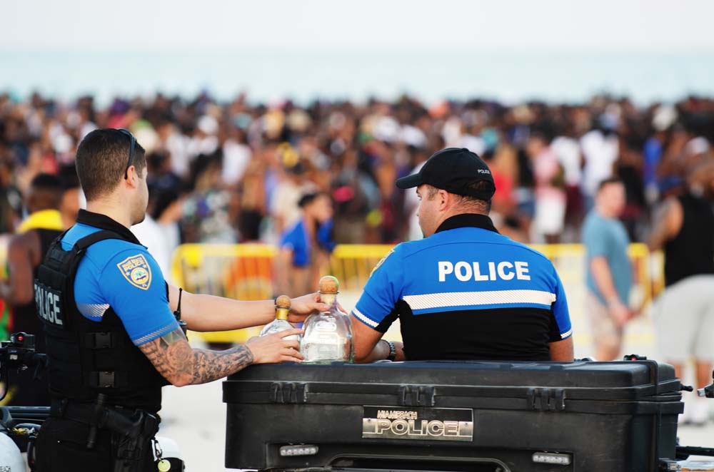 Police officers monitor crowd gathering at South Beach for annual spring break
