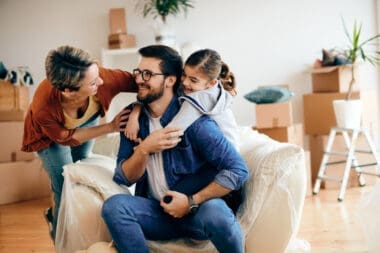 A joyful family chatting and enjoying themselves as they move into a new home