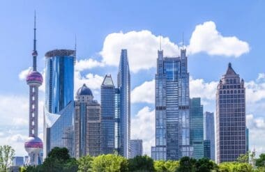 The iconic Oriental Pearl TV Tower stands tall amidst Shanghai's skyline, surrounded by the vibrant energy of the city's financial district
