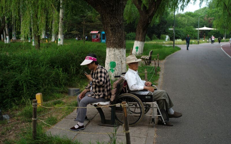 Elderly people rest at a park on a summer day in Beijing