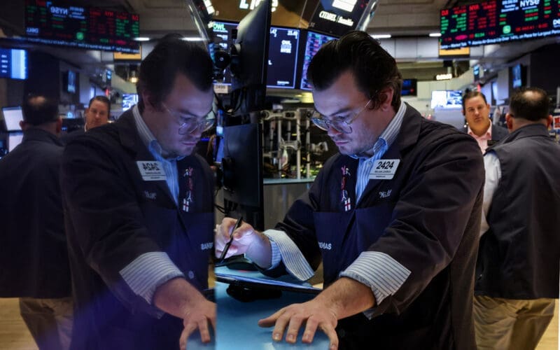 Traders work on the floor of the NYSE in New York