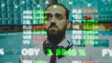 A business expert analyzes stock market charts and statistical graphs using AR visualization technology in a close-up view