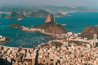 Aerial view of Rio de Janeiro, bathed in sunlight, nestled between the sea and hills in Brazil