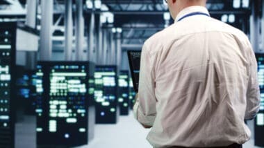 An engineer executing code and monitoring server resources in a data center