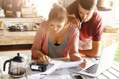 Couple experiencing financial strain from rising living expenses