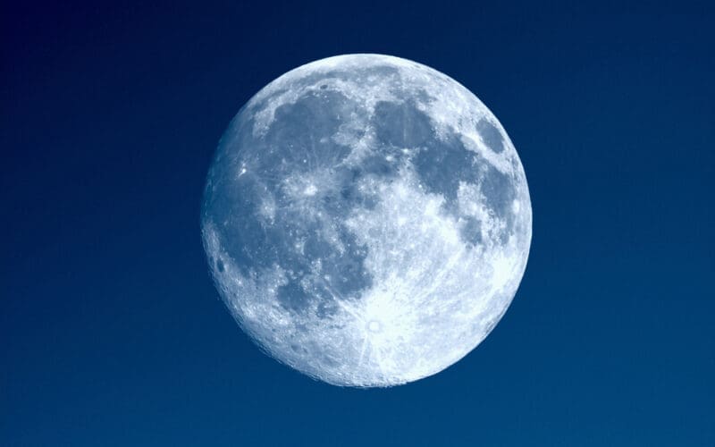 Full moon seen with an astronomical telescope over blue sky. Photo by Shutterstockcom - Claudio Divizia