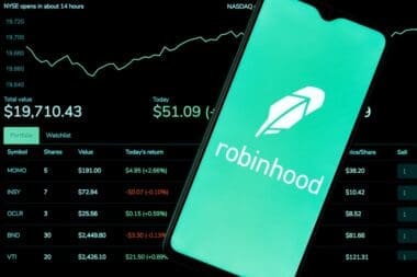 Robinhood Markets is an American broker-dealer company. A smartphone with the Robinhood logo on the background of the live trading webpage