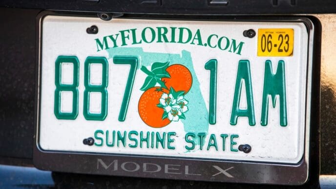 A close-up of a Florida license plate on a Tesla Model X. By Shutterstock.com - Karolis Kavolelis