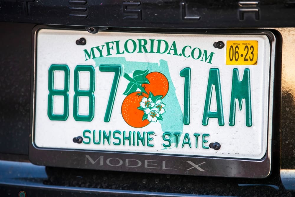 A close-up of a Florida license plate on a Tesla Model X. By Shutterstock.com - Karolis Kavolelis