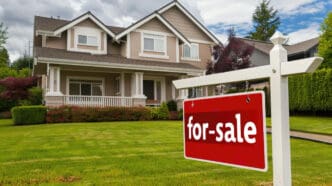 A stunning real estate photograph of a suburban home with a forsale sign in the yard