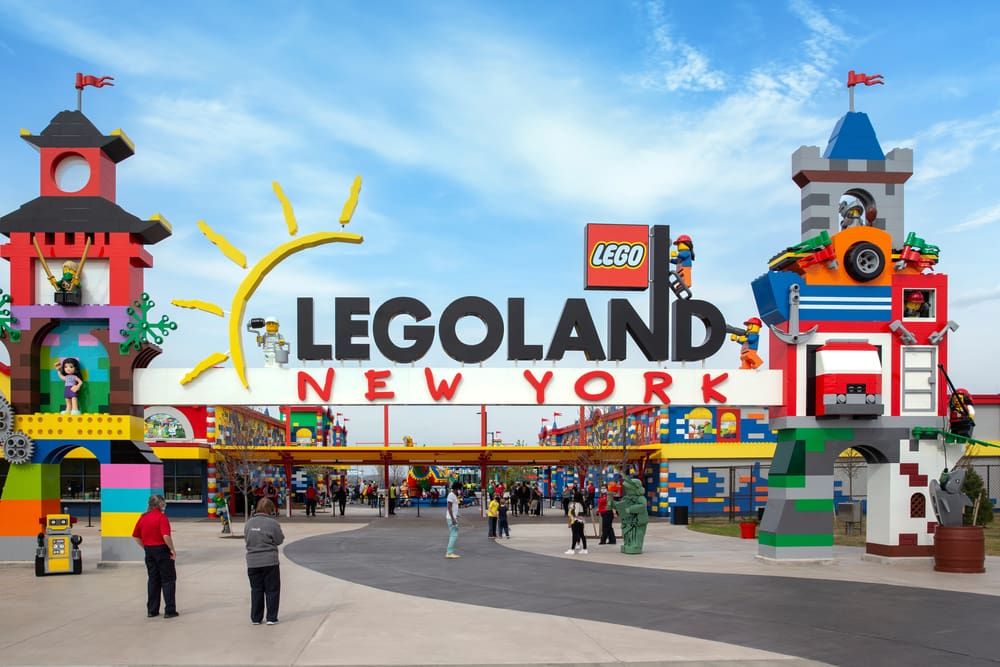 Brooklyn, NY - April 24 2021 Visitors pass through the colorful entrance gate to Legoland in New York. Lego building blocks. By Shutterstock.com-Renata Ty.
