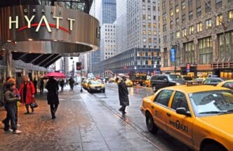 New York, USA - April 06, 2014 Waiting for a taxi outside the Grand Hyatt hotel on East 42nd Street on a wet morning.