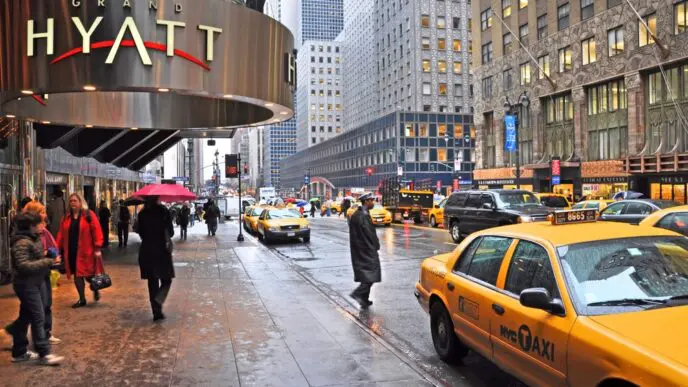New York, USA - April 06, 2014 Waiting for a taxi outside the Grand Hyatt hotel on East 42nd Street on a wet morning.