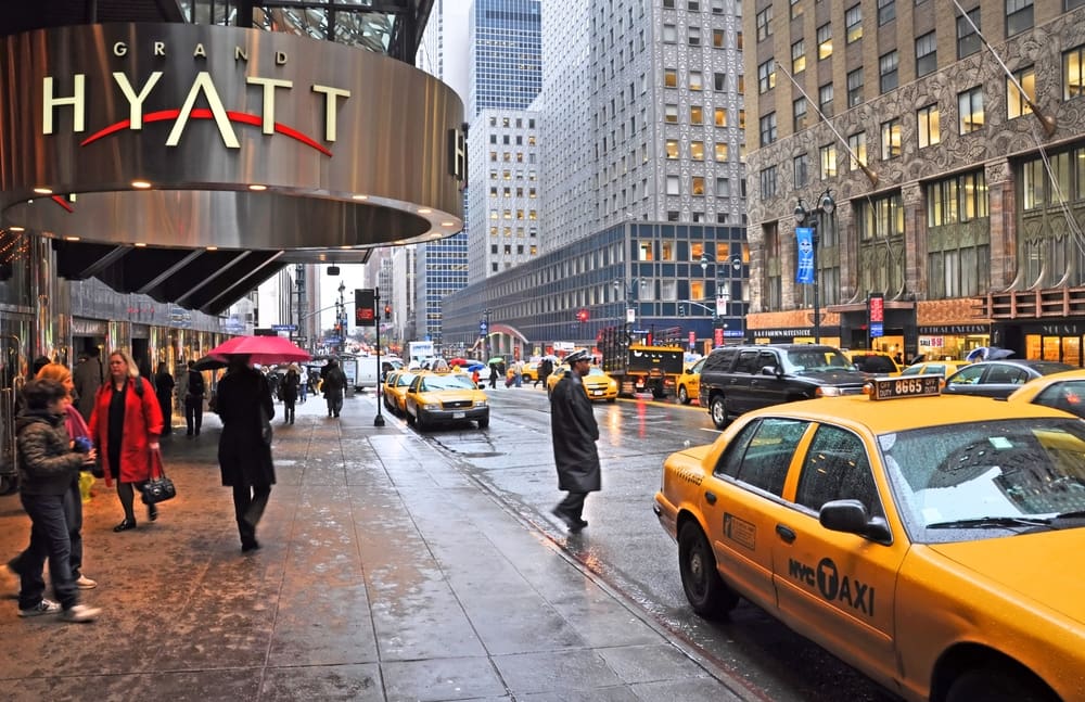 New York, USA - April 06, 2014 Waiting for a taxi outside the Grand Hyatt hotel on East 42nd Street on a wet morning.