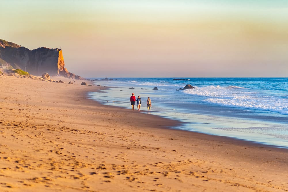 Scenic view of the Zuma Beach in Malibu with people enjoying a walk along the beach