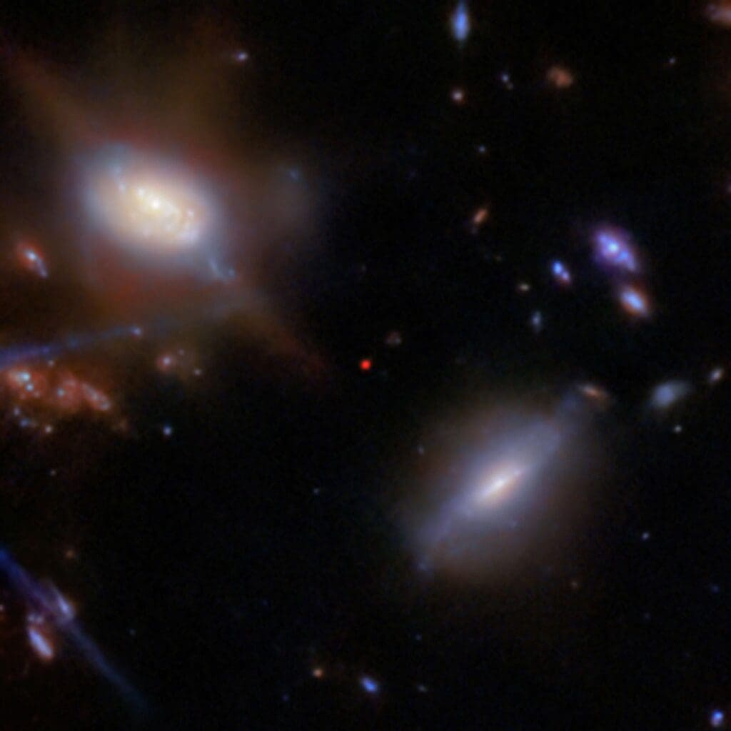 This image shows the galaxy JADES GS-z13-1 (the red dot at center), imaged with NASA’s James Webb Space Telescope’s NIRCam (Near-Infrared Camera) as part of the JWST Advanced Deep Extragalactic Survey (JADES) program.