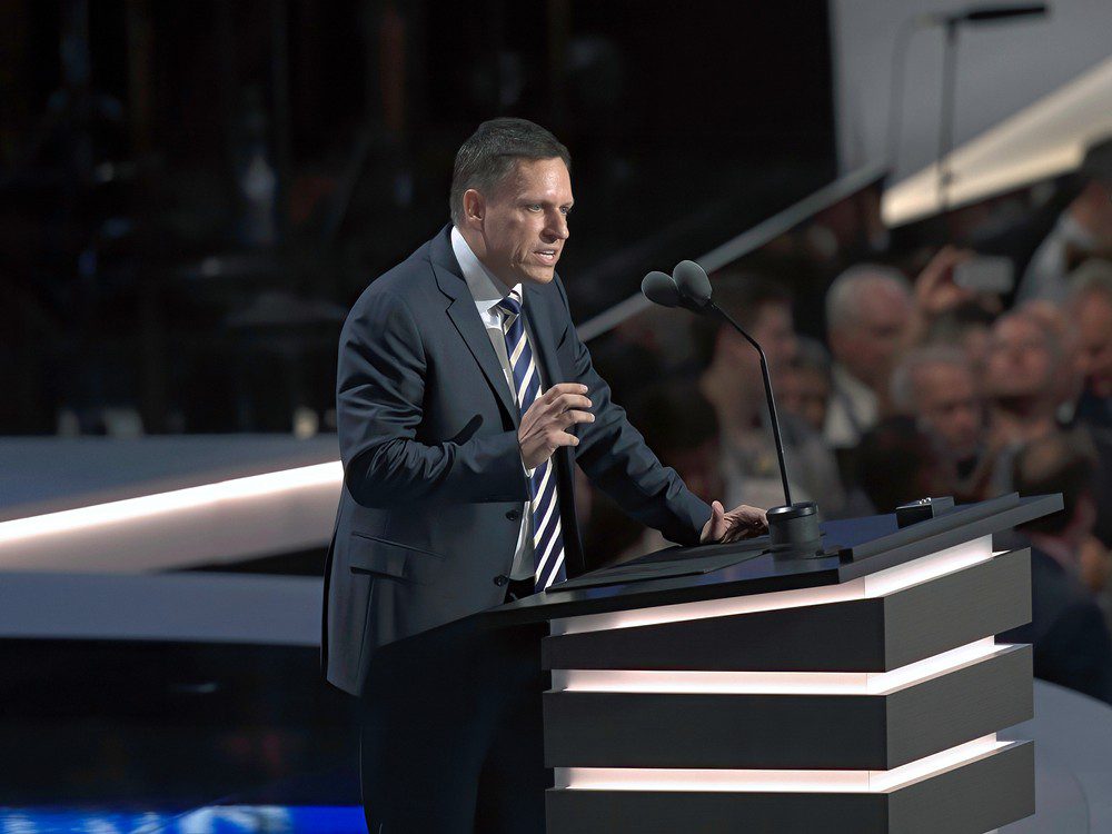Peter Thiel speaks at a podium with two microphones during a political convention