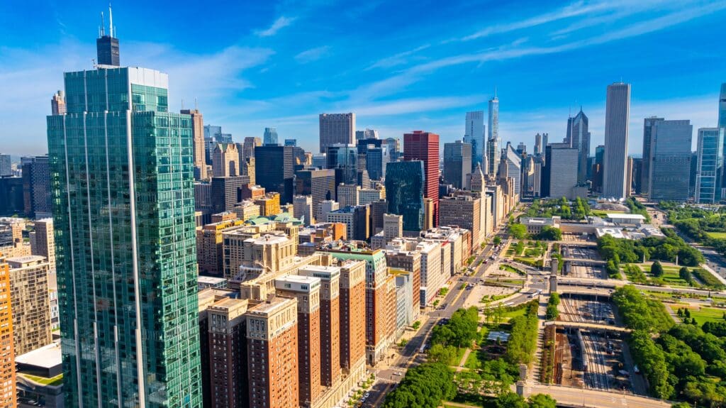 An aerial view of the Chicago skyline bordering the green space of Millennium Park.