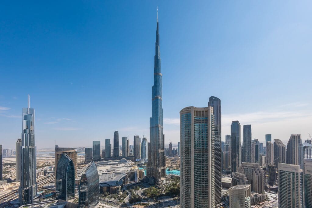 Aerial view of the downtown Dubai skyline, dominated by the towering Burj Khalifa skyscraper.