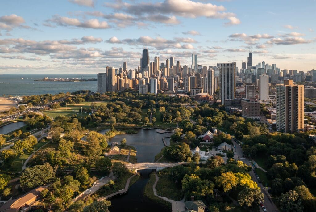 Aerial view of Chicago skyline behind South Pond in Lincoln Park at sunset.