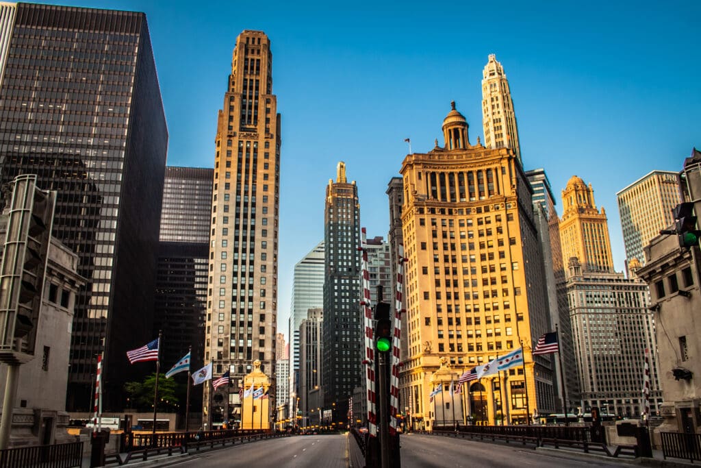 A low-angle view of historic skyscrapers lining the Michigan Avenue bridge in Chicago.
