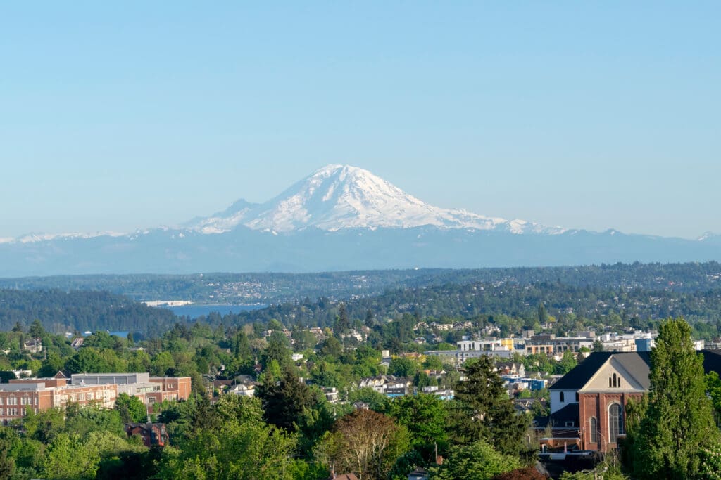 A panoramic view of Southeast Seattle with Lake Washington and the snow-capped Mount Rainier.