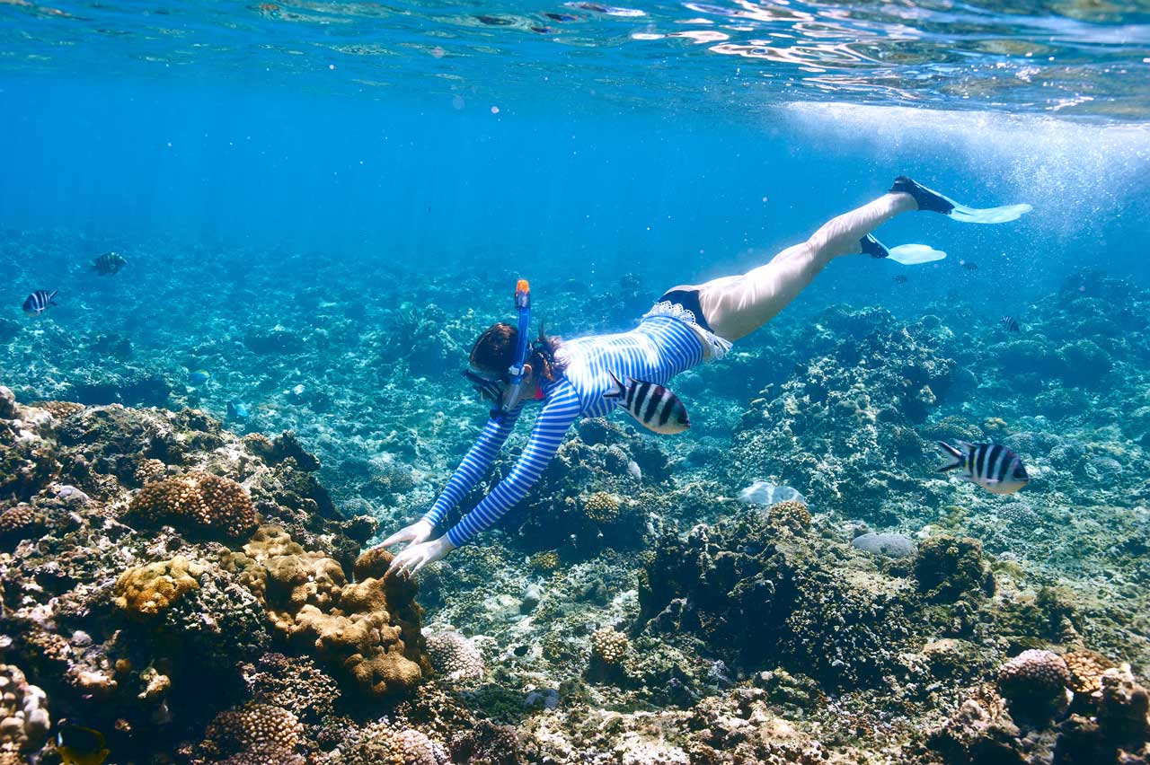 Woman with mask snorkeling in coral reef in South Florida